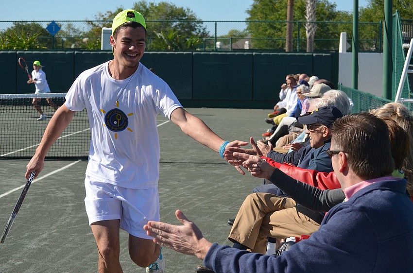 Shadi, 17, high fives the audience as he runs drills during the exhibition on March 15.