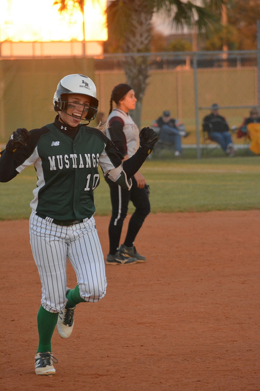 Lakewood Ranch'  s Kinsey Goelz smiles after hitting a solo home run.