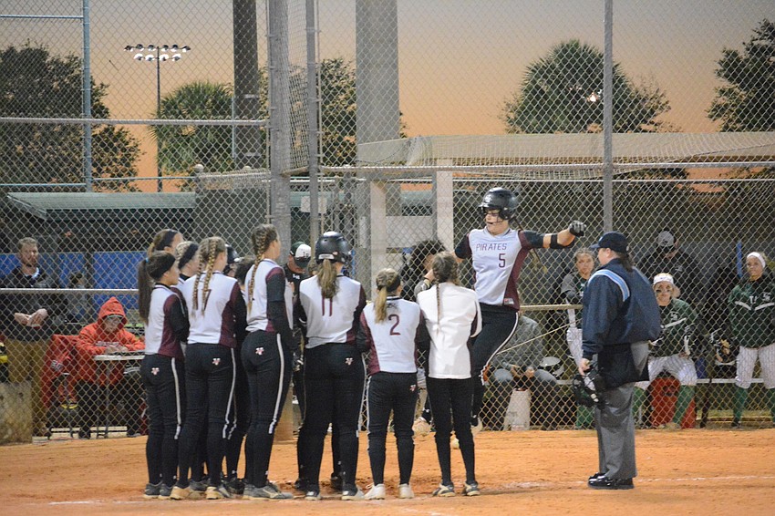 The Pirates greet Sarah Crawford after her home run.