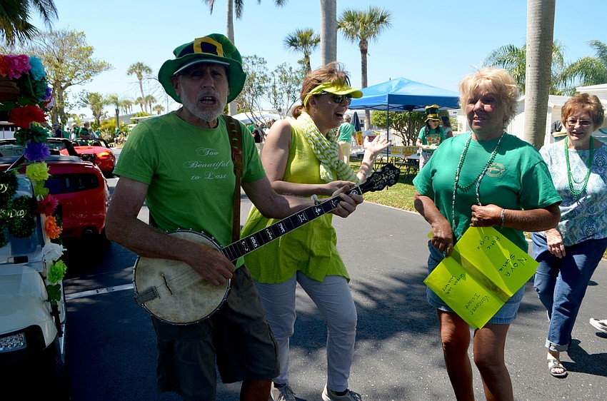Stephen Richer, Laurie Smith and Karen Kroll sing and dance following the parade.
