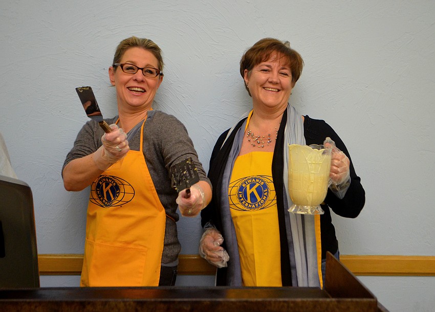 Marie Fikus and Riana Rawson are all smiles as they prepare piles of pancakes for the annual breakfast.