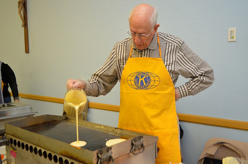 Richard March pours pancake batter. Club President Steve Branham estimates that they made more than 1,000 pancakes during the breakfast.