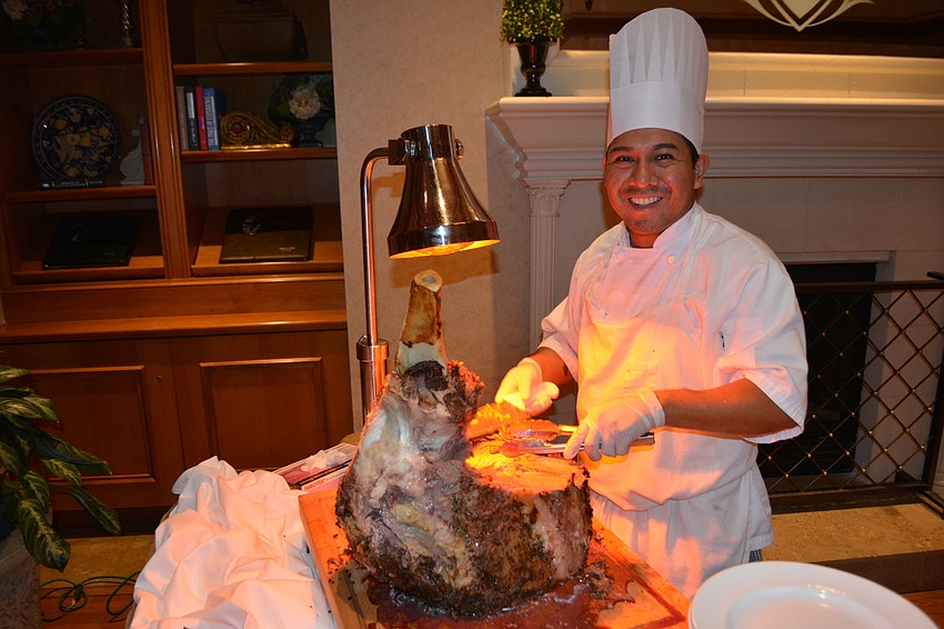 Lakewood Ranch Country Club employee Angel Millne cuts a slice for prime rib at the gala.
