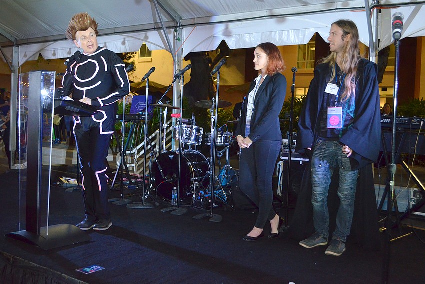 Ringling College of Art and Design President Larry Thompson congratulates $5,000 scholarship recipients Rosadia Fortunato and Nathan Clark at An Evening at the Avant-Garde on March 18 at Ringling College of Art and Design.