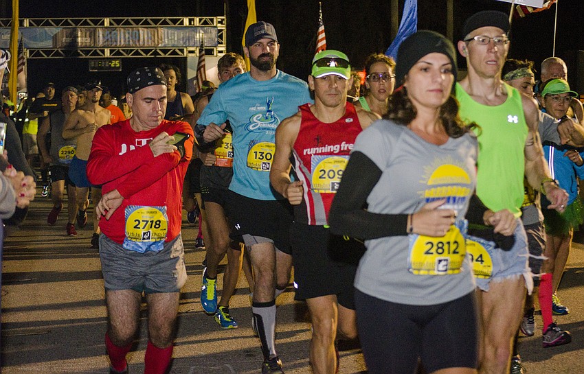 Runners leave the starting line of the First Watch Sarasota Half Marathon.