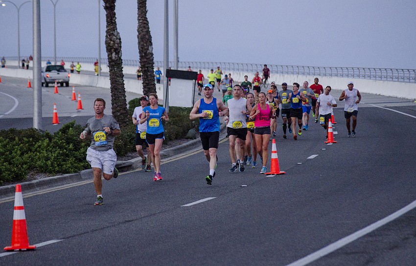 Runners cross the Ringling Bridge during the First Watch Sarasota Half Marathon.