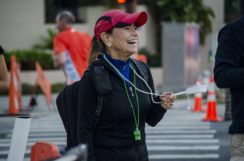 Monica Condon cheers on runners of the First Watch Sarasota Half Marathon.