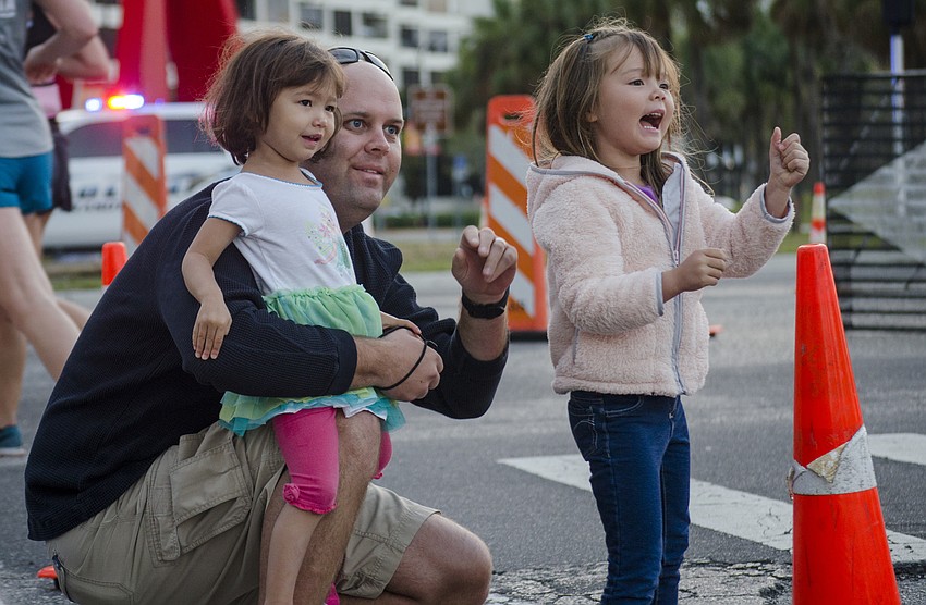Emi, Nathan and Mina Busscher cheer on Miki Busscher (not pictured) as she runs the First Watch Sarasota Half Marathon.