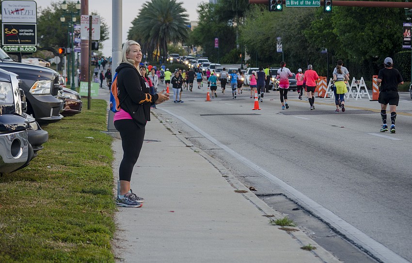 Jody Sayre cheers on runners of the First Watch Sarasota Half Marathon.