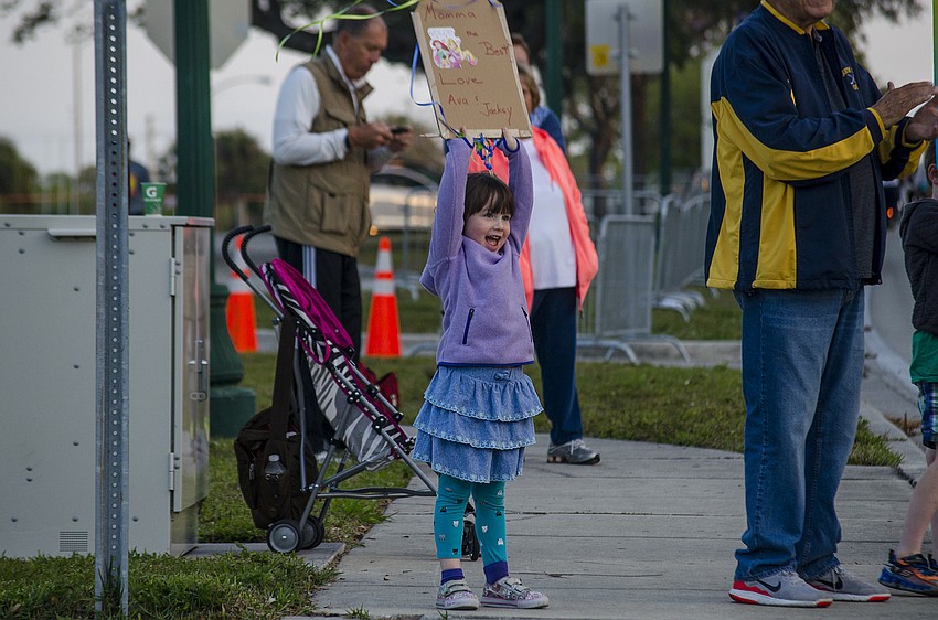 Ava Chapman cheers on her mother as she runs the First Watch Sarasota Half Marathon.