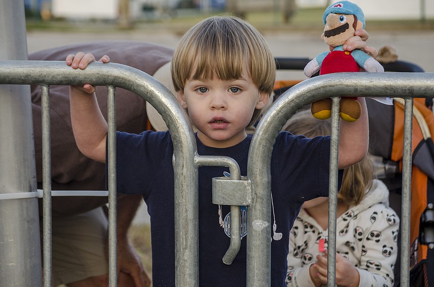 Louis Carlin watches runners participate in the First Watch Sarasota Half Marathon.