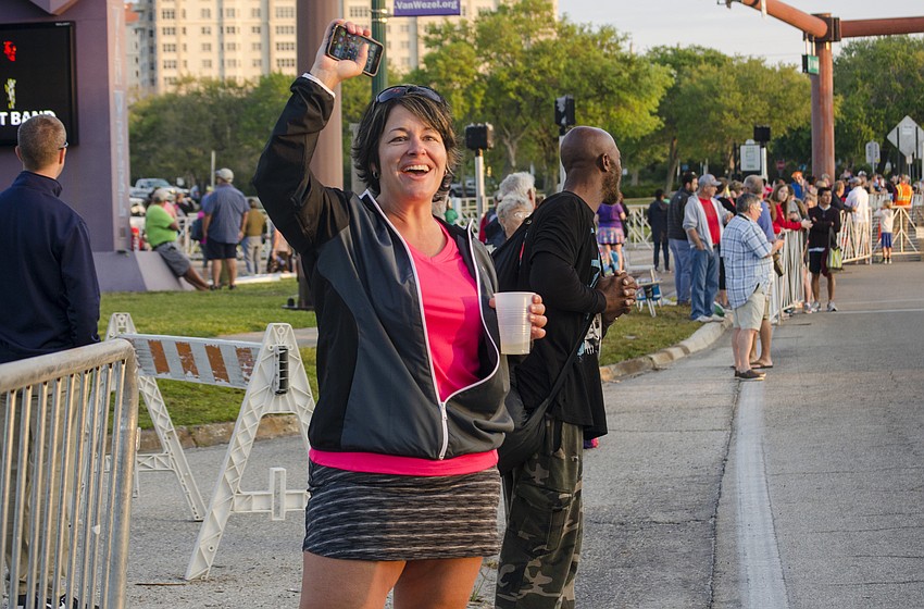 Brenda Smith cheers on runners of the First Watch Sarasota Half Marathon.
