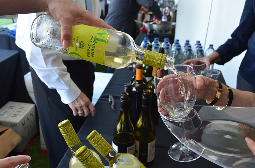 Kelly Fried pours a glass of Marques de Caceres Verdejo at the Celebrity Chefs Food & Wine Tasting on March 21 at the Resort at Longboat Key Club.