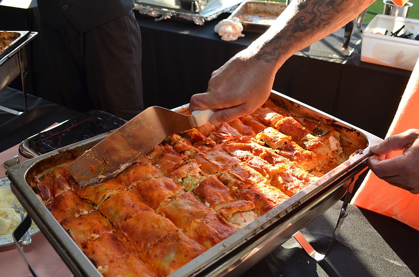 The staff of Beulah Restaurant serves vegetable lasagna at the Celebrity Chefs Food & Wine Tasting on March 21 at the Resort at Longboat Key Club.