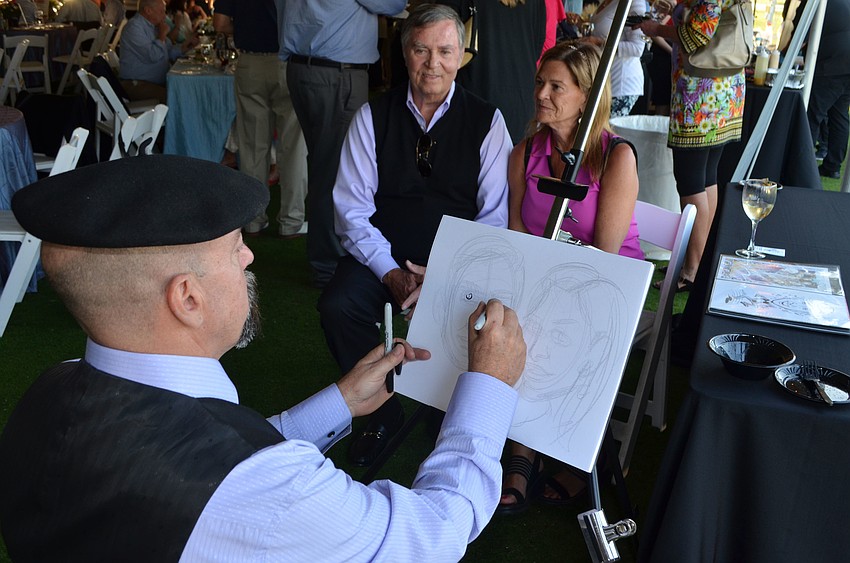 Caricaturist Michael White does a portrait of Michael Herney and Claudia Cardillo at the Celebrity Chefs Food & Wine Tasting on March 21 at the Resort at Longboat Key Club.
