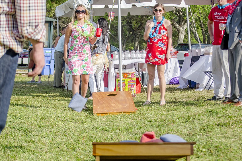 Alex Trigg and Molly Laramie play corn hole at the Greater Sarasota Chamber of Commerce Hob Nob.
