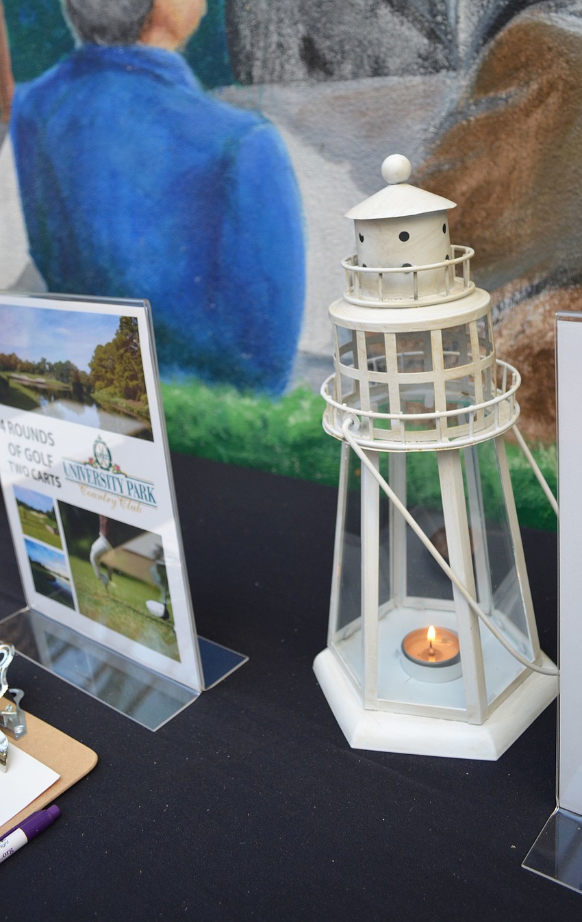 Auction table was covered in lighthouse decorations at the second annual Art in the Dark on March 24 at Michael’s On East.