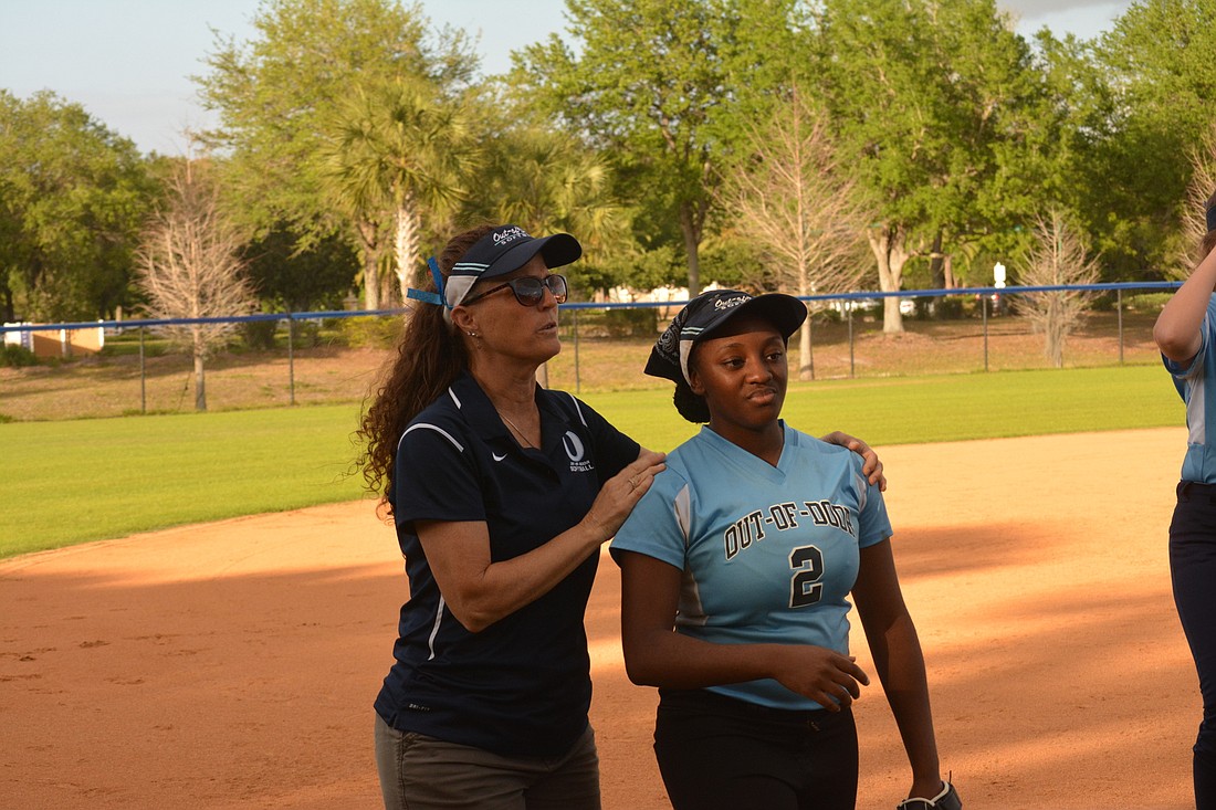 Julianne Garcia talks to Kiarra Womack on the way to the dugout.