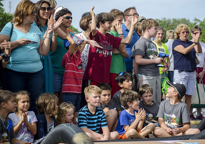 Racegoers cheer as teams compete in the blind competition.