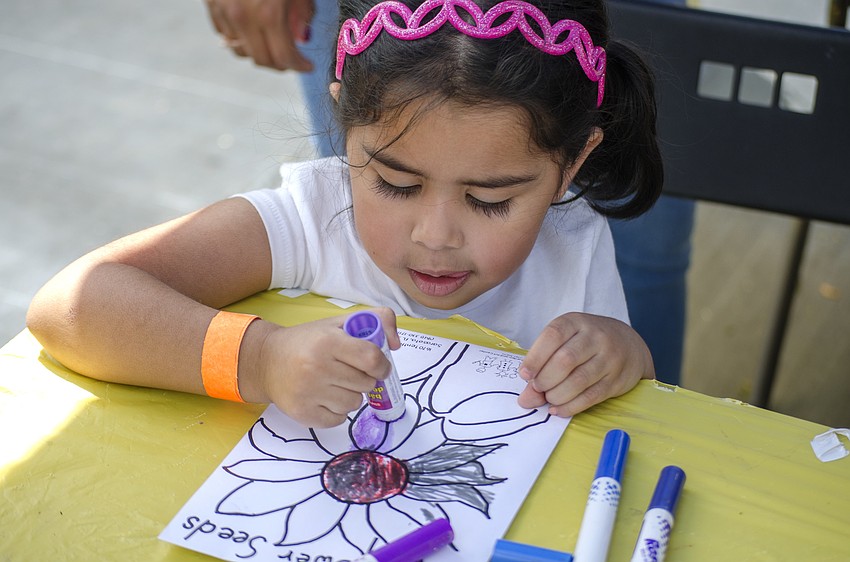 Emely Barbosa colors at the craft tent.