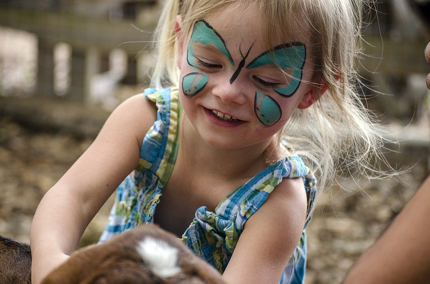Alyssa Martinez pets a goat.