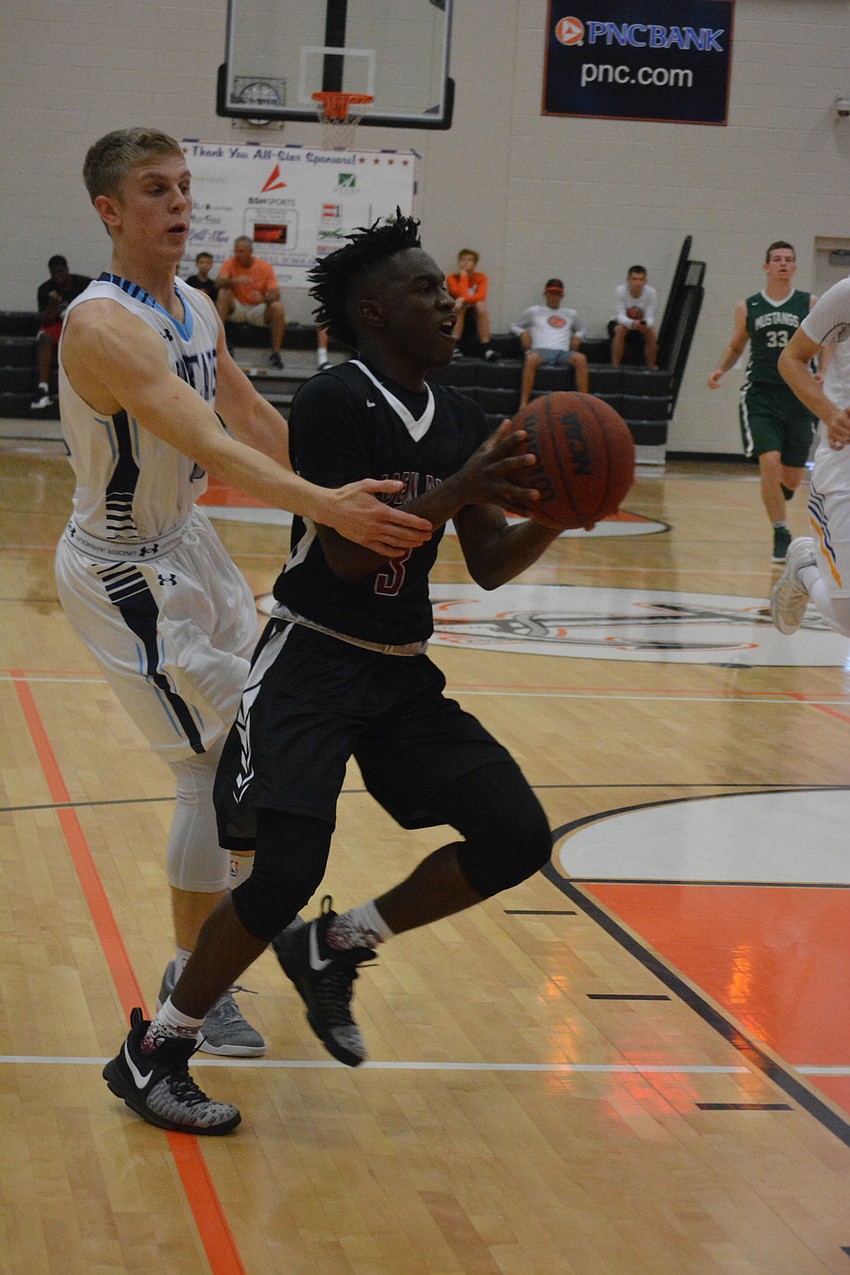 Braden River'  s Deoni Cason gets past a defender during the boys game.
