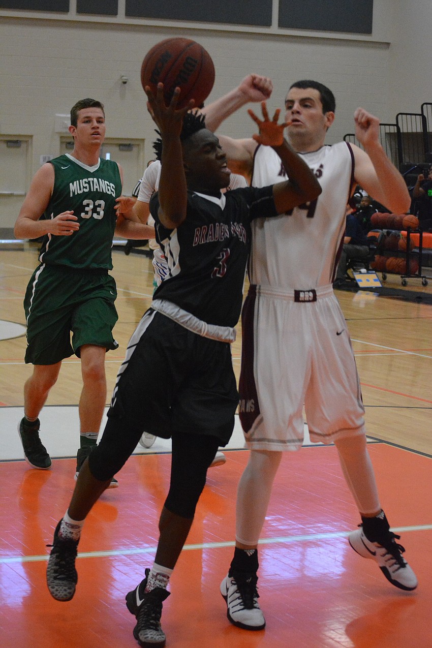 Braden River'  s Deoni Cason bangs into Riverview'  s AJ Caldwell in the post during the boys game.