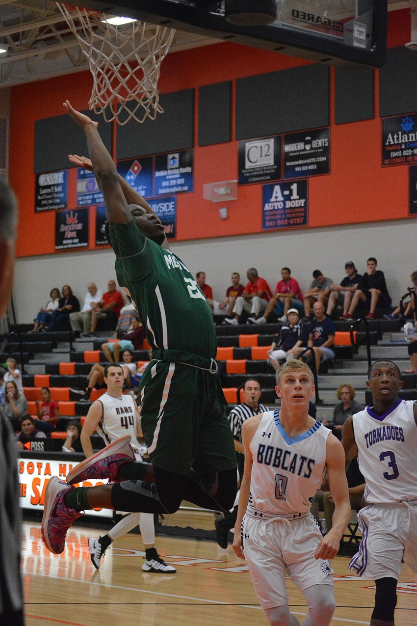 Lakewood Ranch'  s Devin Twenty flies through the air after getting fouled during the boys game.