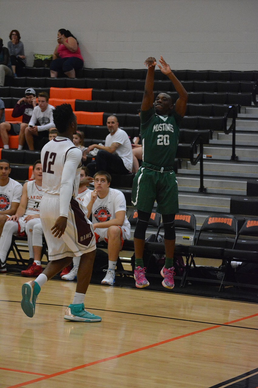 Lakewood Ranch'  s Devin Twenty hits a three over Riverview'  s Brion Whitley during the boys game.