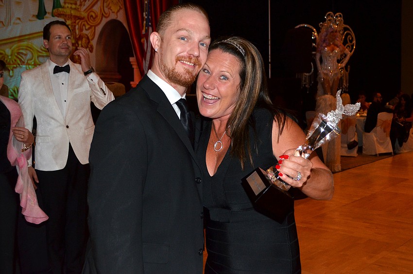 Joshua Alexander and Carrie Walsh celebrate after accepting the Top Amateur Couple award for Peter and Carrie Walsh at Sarasota Challenge on March 26 at Hyatt Regency Sarasota.