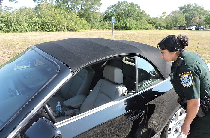 Leticia Leon, a deputy with the Manatee County Sheriff' s Office, checks out a car where the owner left the door unlocked and the window down. Leon patrols Lakewood Ranch area neighborhoods.