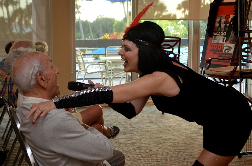 Connie Scardelli has Stan Horwich sing part of “All That Jazz” during her performance at Beachplace on March 28.