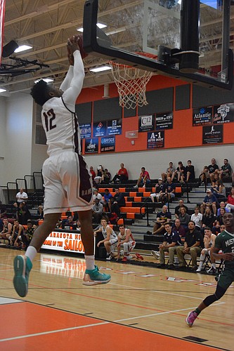 Riverview&#39;  s Brion Whitley grabs an alley-oop from Rams teammate AJ Caldwell.