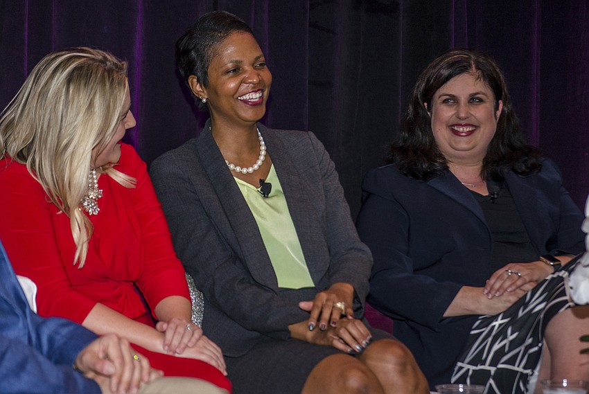 Panel members Eric Christy, Tonya Willis Pitts and Christine Robinson chat before the panel.