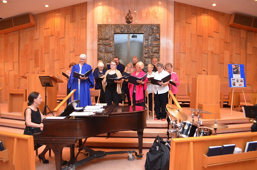 The choir, led by Ann Stephenson-Moe warms up before the concert.