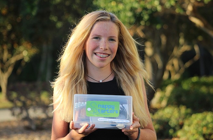 Out-of-Door Academy student Mairead Studdiford holds her new business idea, Snappy Starters.