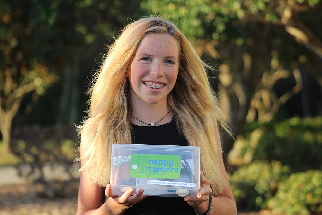 Out-of-Door Academy student Mairead Studdiford holds her new business idea, Snappy Starters.