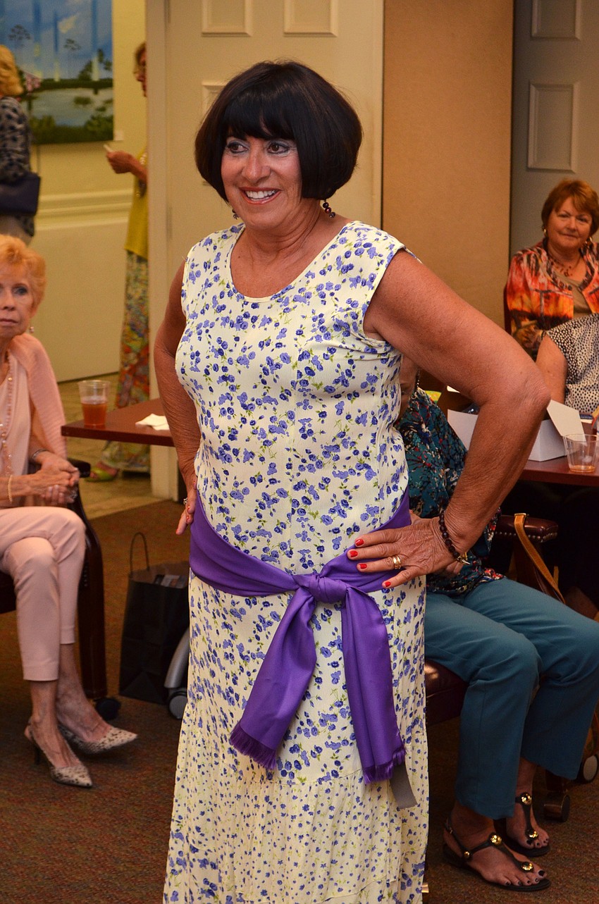 Marianne Cleary models a violent garden party dress available at Designing Women Boutique during the style show on March 30 at Designing Women Boutique.