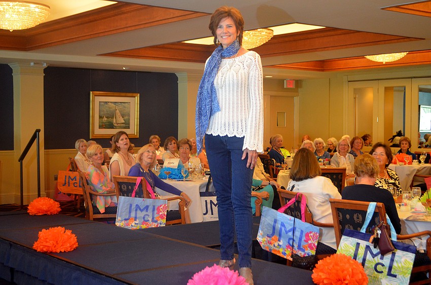 Lynn Coffin smiles as she works the runway during the March style show at Bird Key Yacht Club.