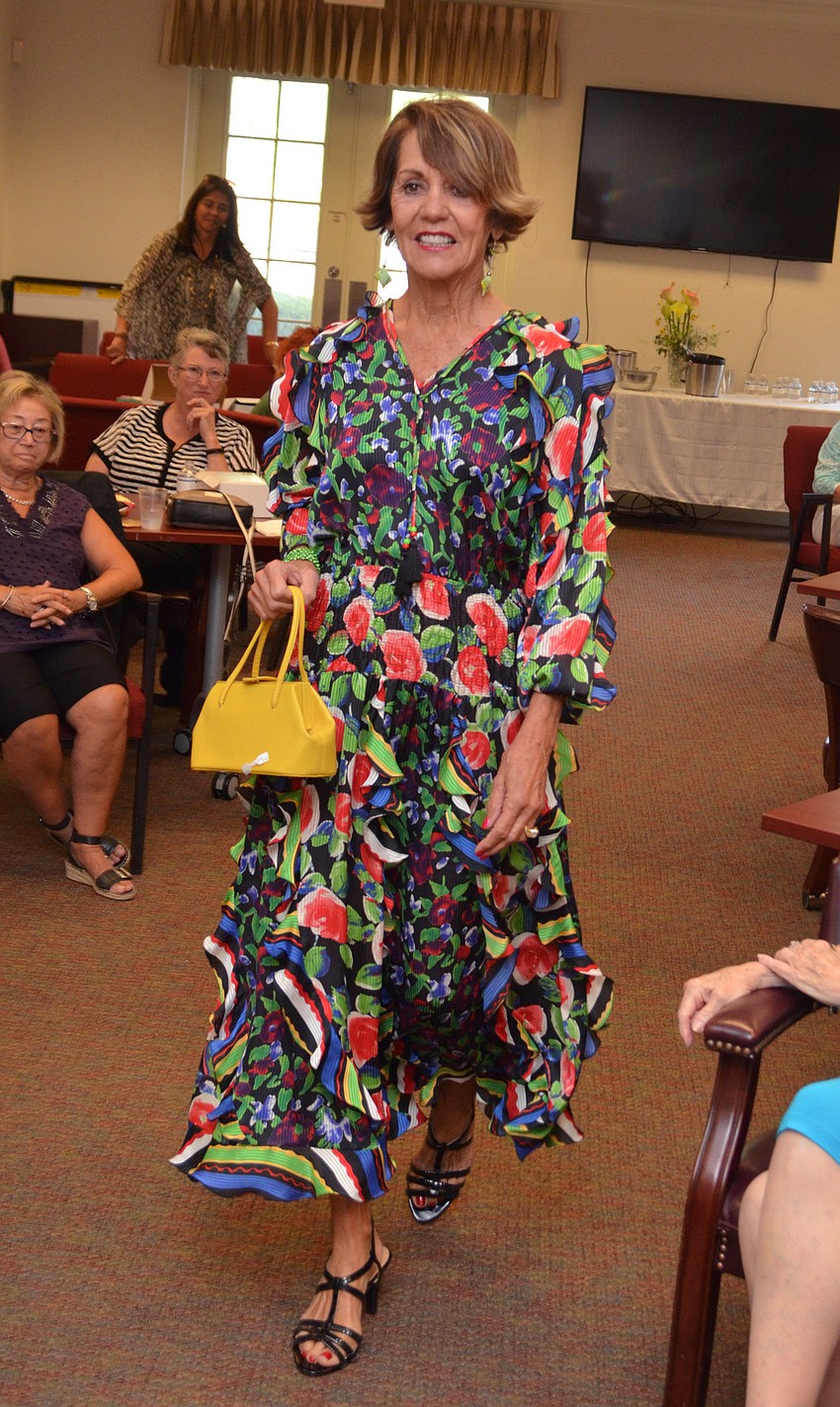 Jane Krombeen models a Diane Freis tunic available at Designing Women Boutique during the style show on March 30 at Designing Women Boutique.