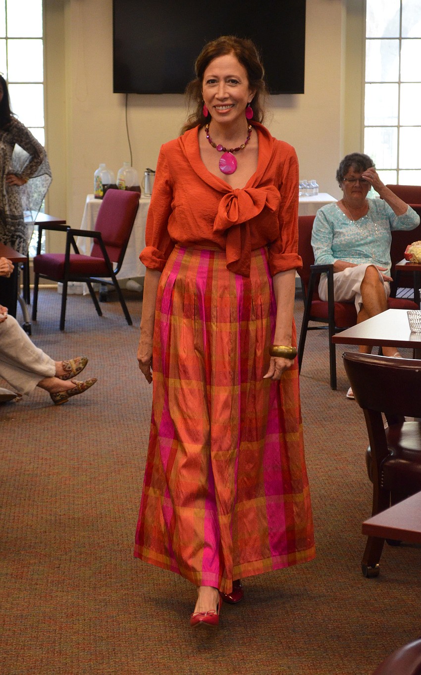 Donna Moffit dons a Maggie London skirt and several other items available at Designing Women Boutique during the style show on March 30 at Designing Women Boutique.