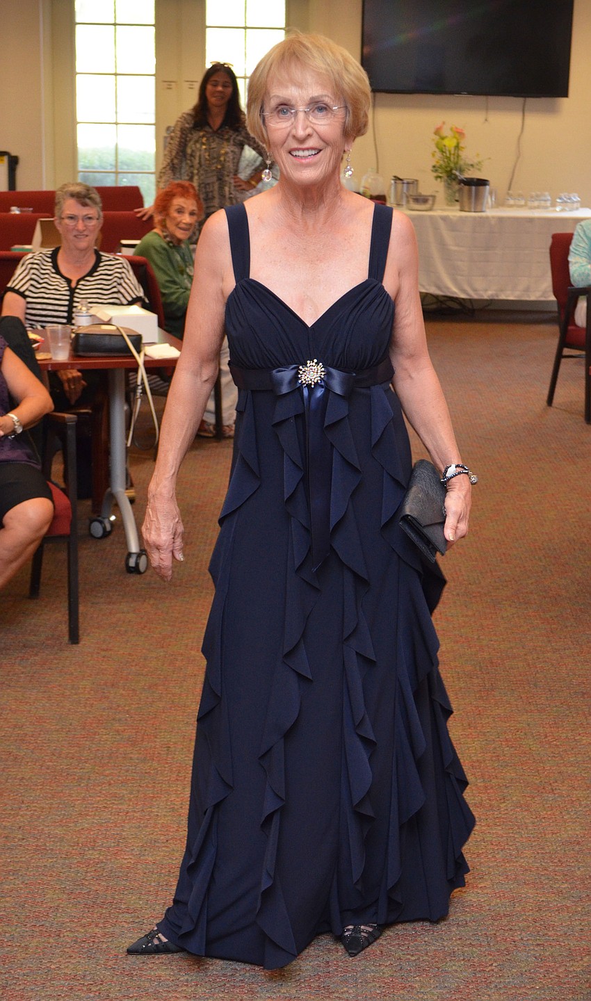 Sue Lamy appears as the “belle of the ball” in a Linda Bernell gown available at Designing Women Boutique during the style show on March 30 at Designing Women Boutique.