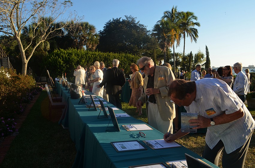 Seabird supports bid on silent auction items during cocktail hour.