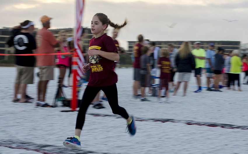 Sophia Augustine finishes the one-mile children' s fun run.
