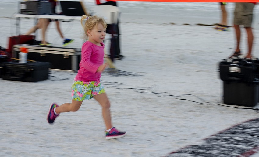 Madeleine Leaf finishes the one-mile children' s fun run.