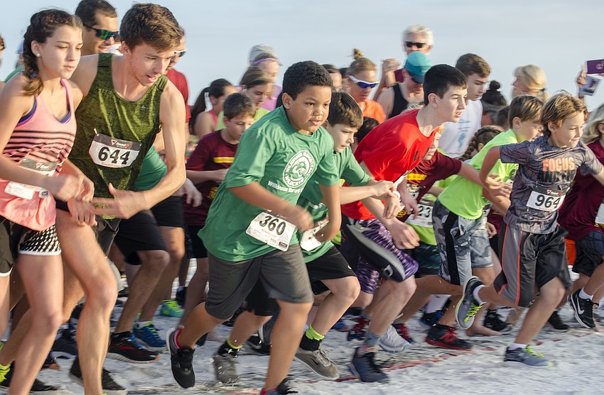 Runners leave the starting line of the 31st annual Run for the Turtles.