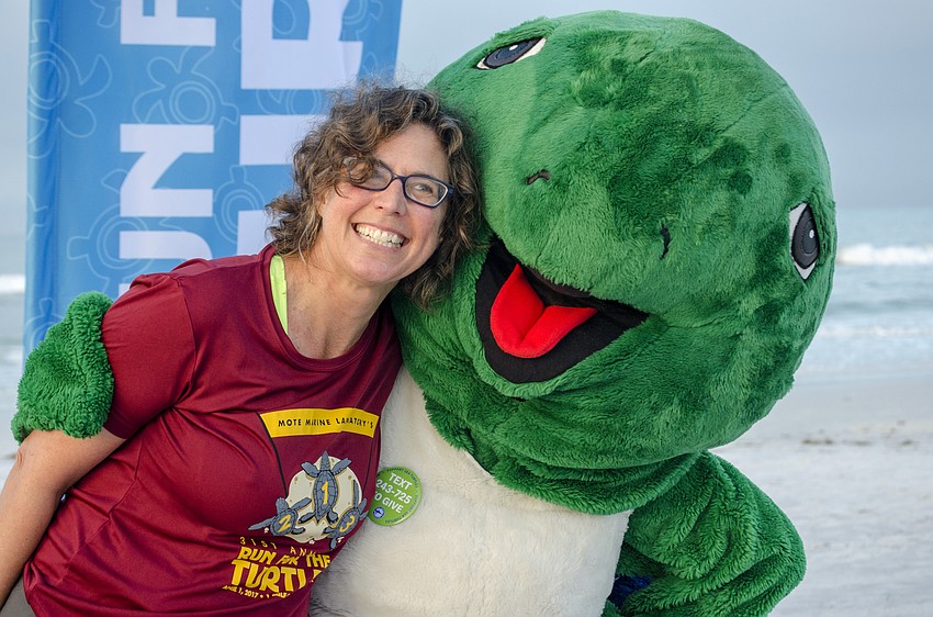 Karen Stults poses with Shelley the Sea Turtle.