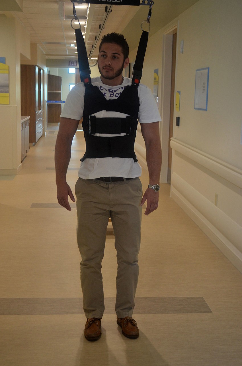Zack Watson demonstrates how the Bioness Vector System works. The harness helps those get out of chairs and walk following various injuries or stroke.
