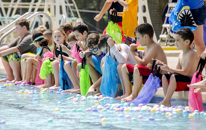 Children line the pool before one of the eight egg hunts during the the Arlington Park Spring Splash.