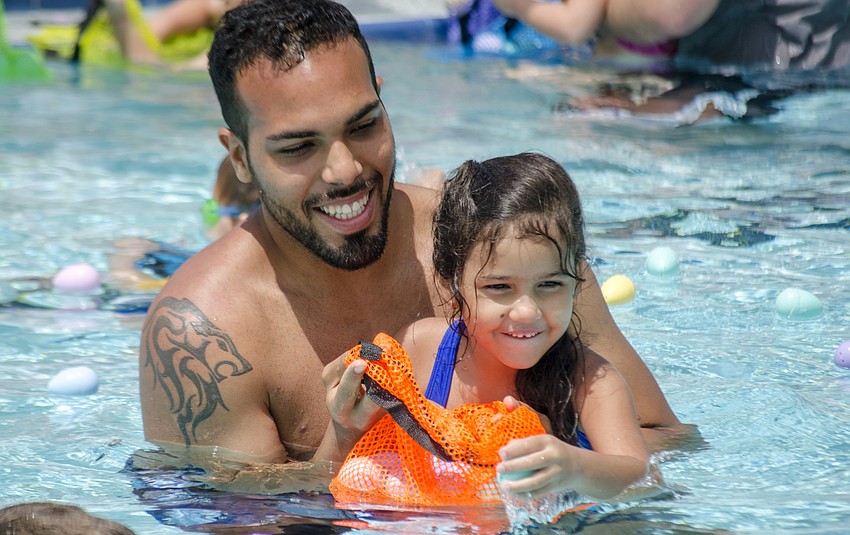 Jesus Thompson and Karolina Bonano participate in an Arlington Park Spring Splash  egg hunt.